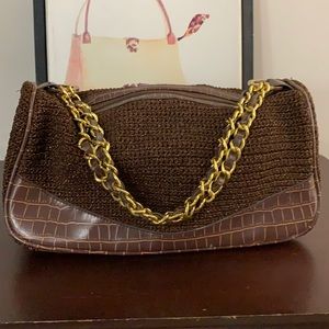 A brown handbag with Chanel like handles.